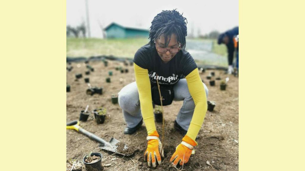 Pearl Andrew planting a tree at Kawartha Land Trust's Dance Nature Sanctuary in Selwyn