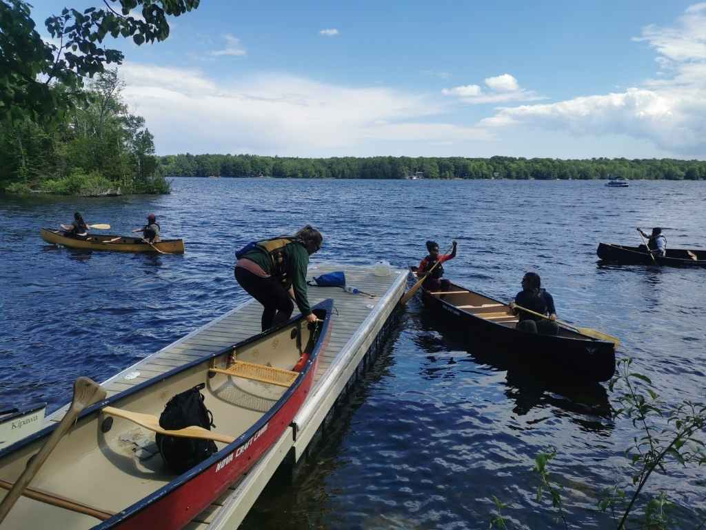Attendees learning paddling techniques in Pigeon Lake as part of Second Annual Women's Backcountry Skills clinic held on Big (Boyd/Chiminis) Island