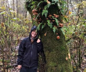 Sam Clapperton leaning against a large tree