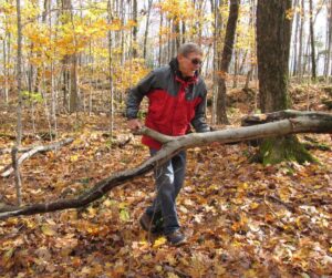 Evan Thomas removing downed limb from trail at Ingleton-Wells property
