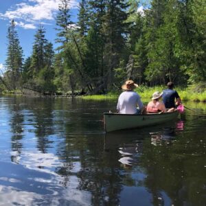 Three people in a canoe at the edge of Kawartha Land Trust's DeNure Conservation Easement Agreement. Photo courtesy Steven DeNure