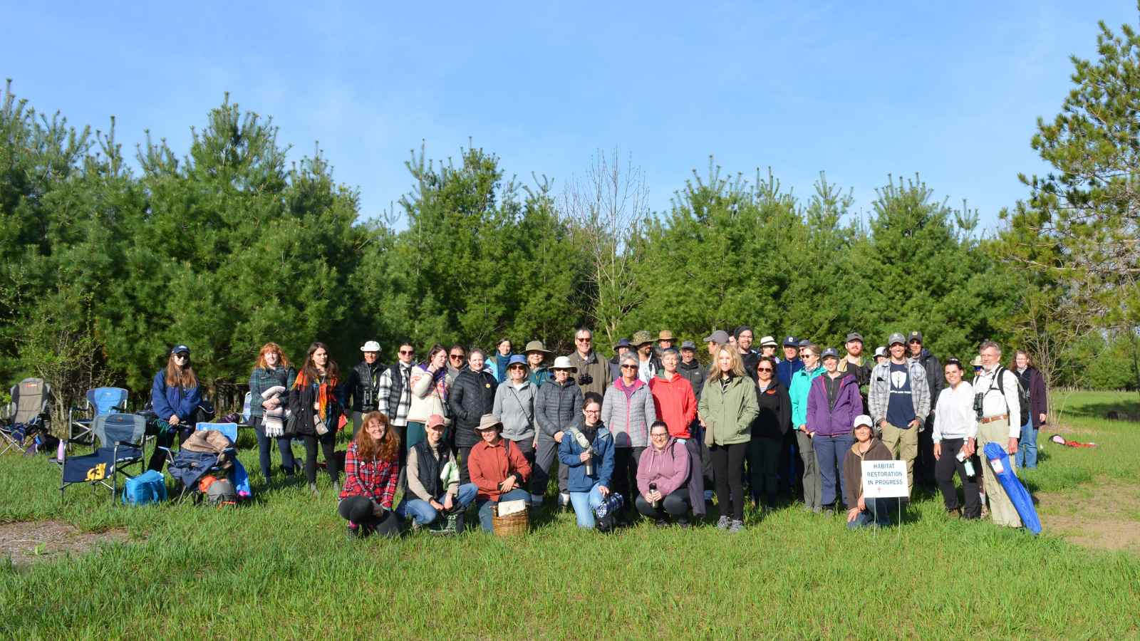 Group photo of Creators Garden Birds team, Kawartha Land Trust event attendees and staff on a hillside at Ballyduff Trails