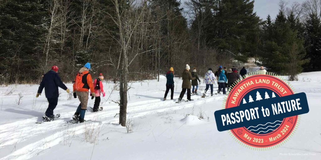 Group snowshoeing on trail. Passport to Nature logo.