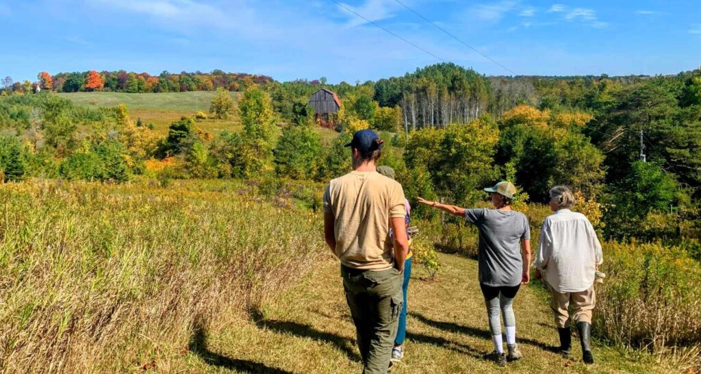 Kawartha Land Trust staff and Partners in Conservation landowner walking on property in Kawarthas