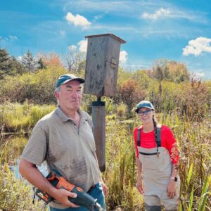 Rob Gouinlock and Rachel Barrington standing next to the newly installed Wood Duck box.