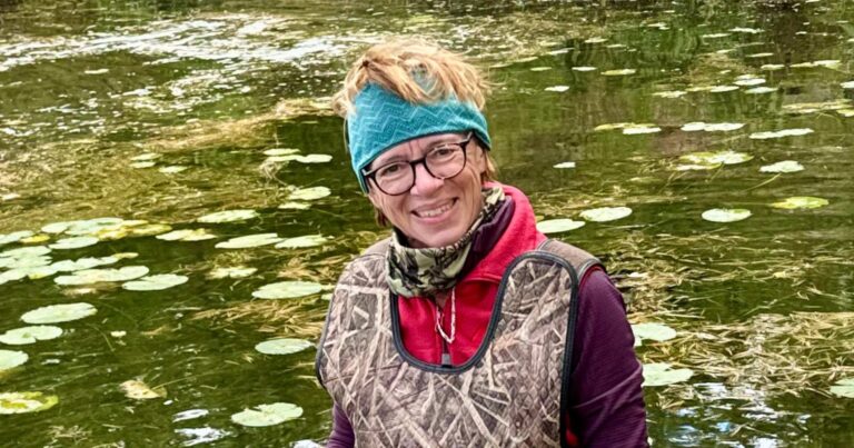 Barb Elliott standing in a wetland as part of a property inventory for Kawartha Land Trust