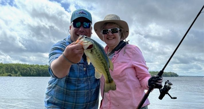 Gary Pritchard holding a fish next to a How to Catch a Fish with Care event participant.