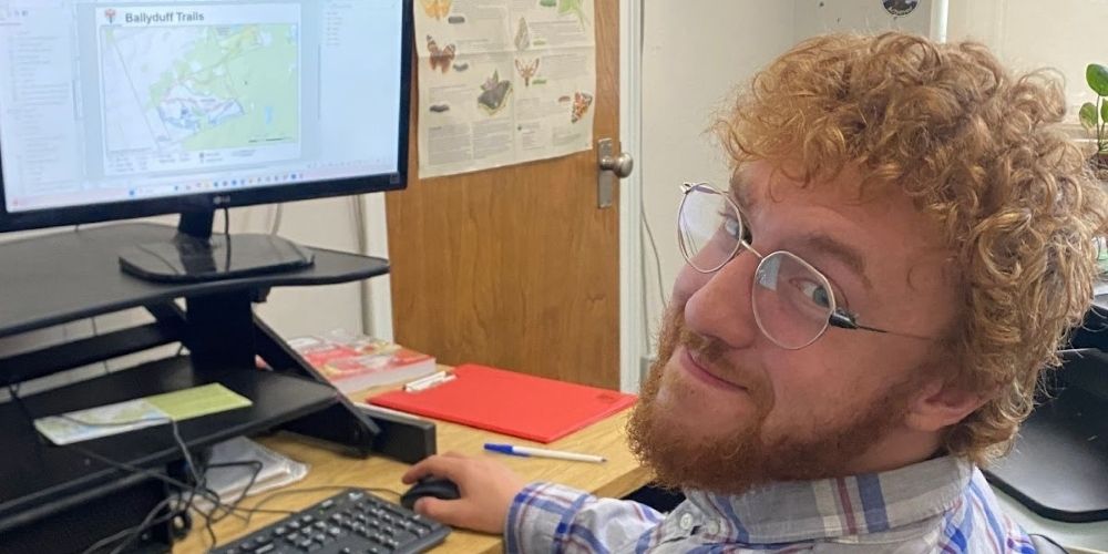 Aaron Pinfold, GIS Technician at computer