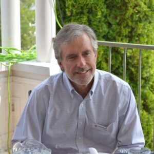 Doug Eberlee sitting at a table and socializing with others at KLT's 2023 AGM.