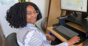 Geanna Collins at her desk in the KLT office.